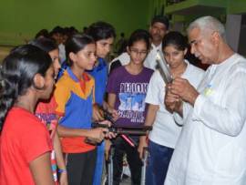 Dr Rajpal (extreme right) giving tips to the budding shooter.jpg